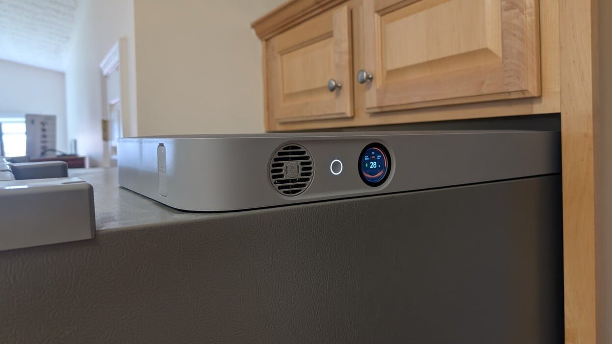 the Jackery FridgeGuard on top of a refrigerator in a kitchen