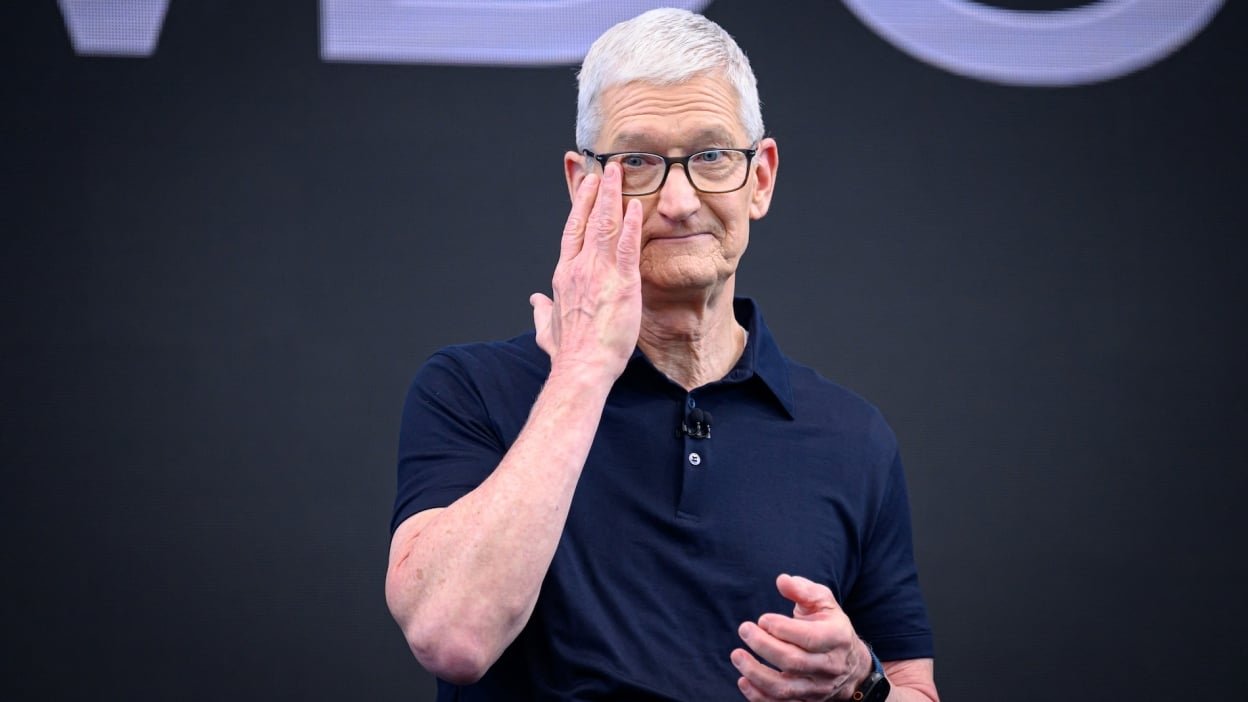 Apple CEO Tim Cook on stage wiping away a tear