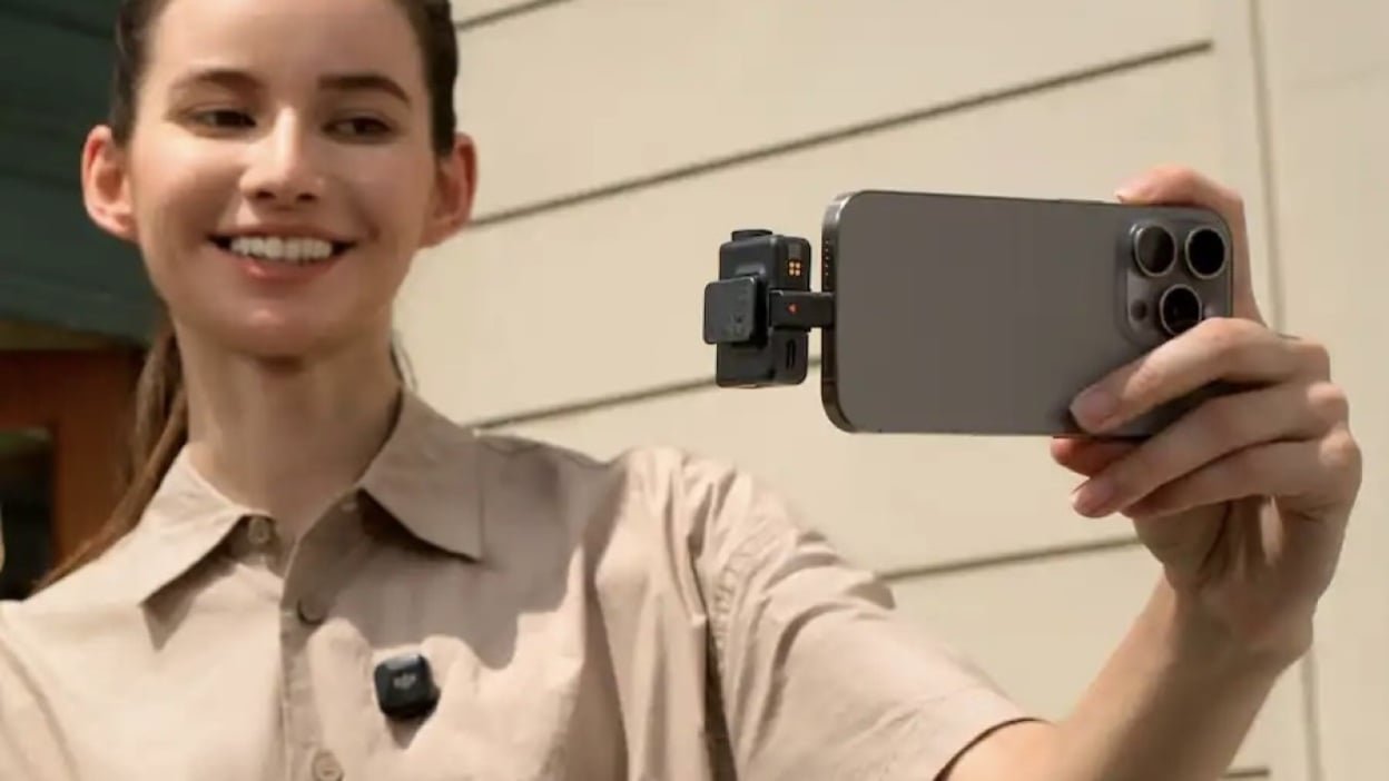 person filming themself with dji mic mini plugged into phone and on shirt