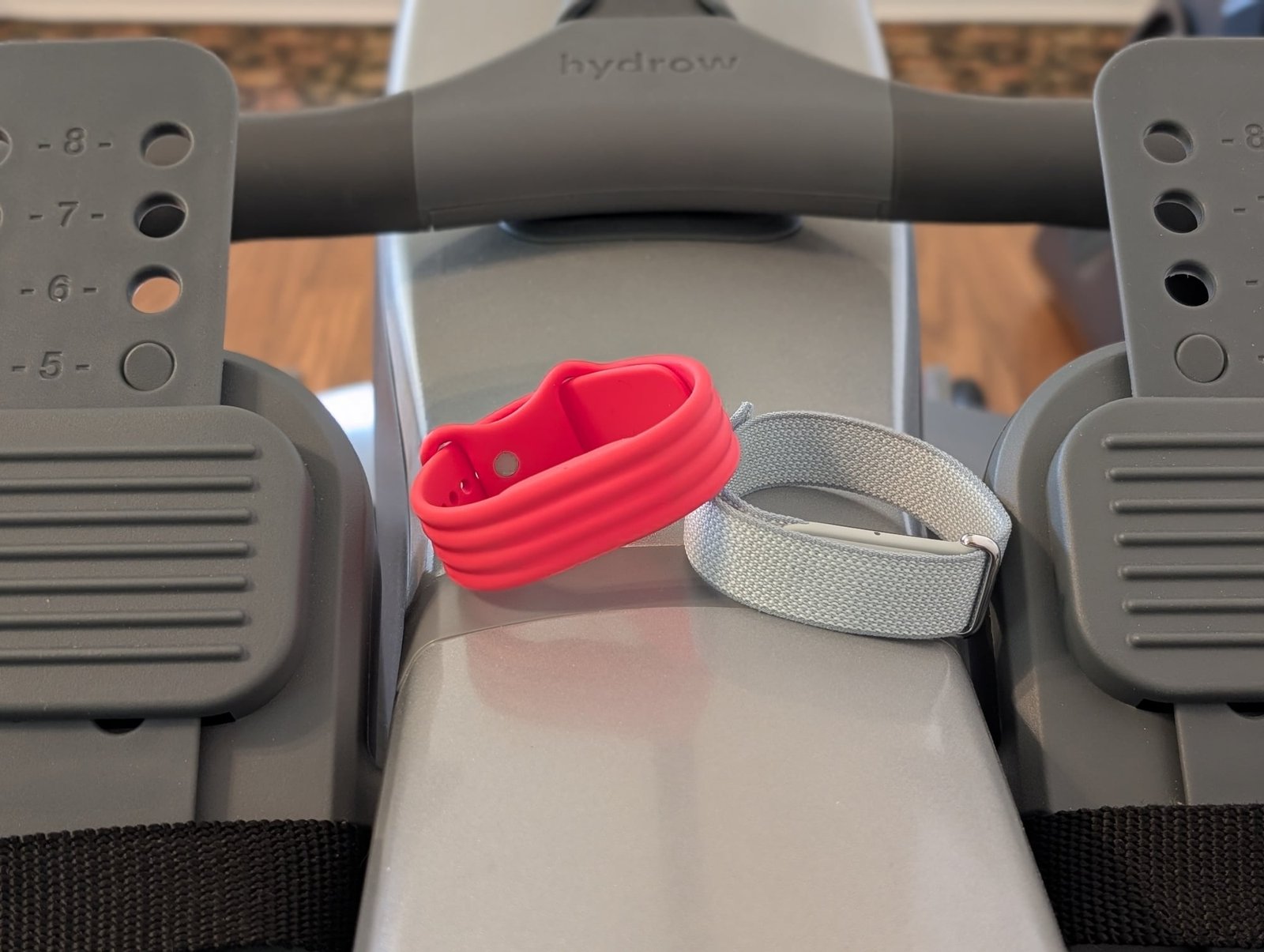 the fitbit air sits on a rowing machine