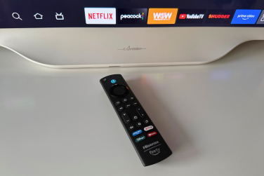 Hisense Déco TV remote laying on dresser near TV
