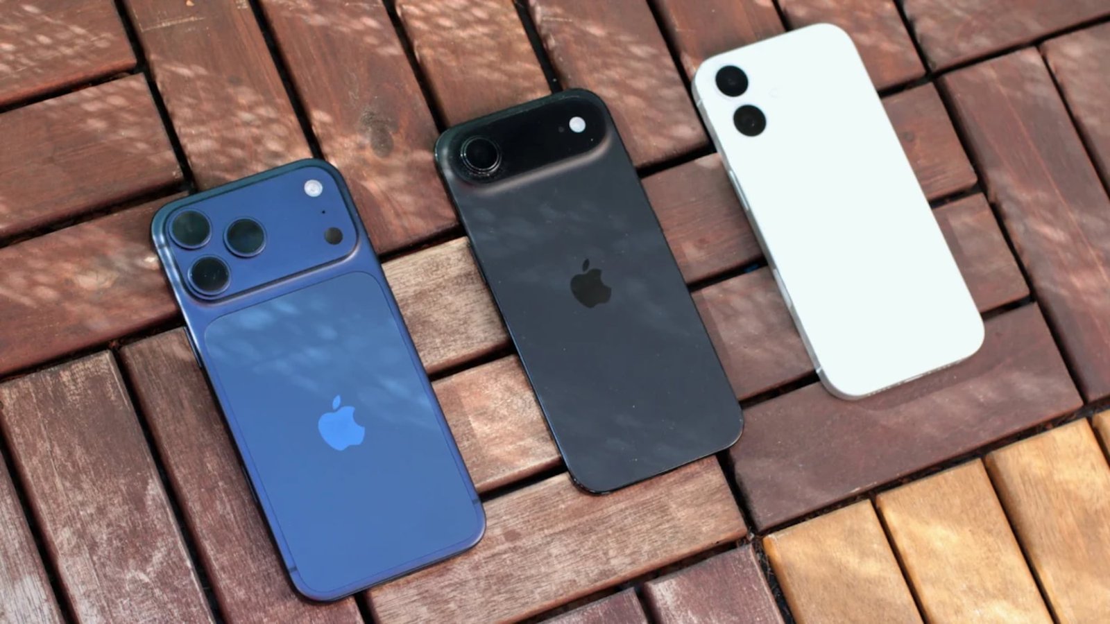 Three iPhones on a table.