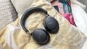 black pair of bose QC ultra headphones on a pillow