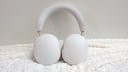 white sonos ace headphones on a white fuzzy blanket