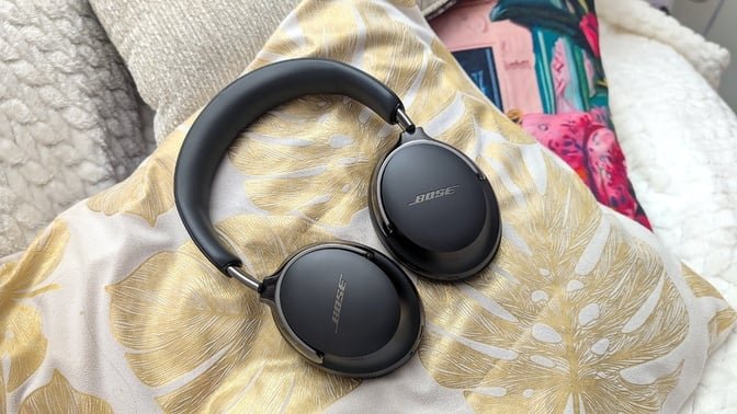 black pair of bose QC ultra headphones on a pillow