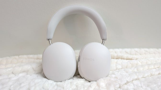 white sonos ace headphones on a white fuzzy blanket