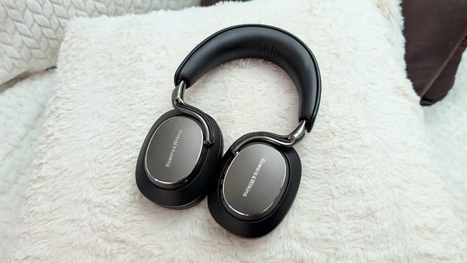 Bowers & Wilkins Px8 S2 headphones on a fuzzy white pillow